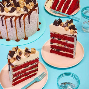 Red Velvet Volcano Cake by Crumbs & Doilies with Oreo crumb icing, cookie dough chunks, and caramel drip.